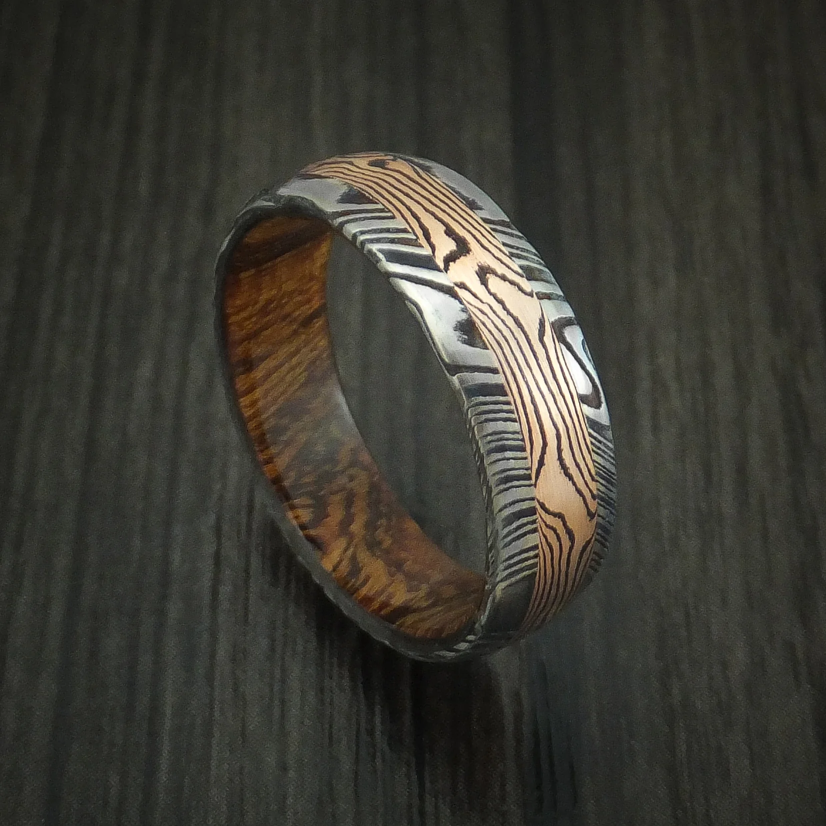 Woodgrain Kuro Damascus Steel Men's Ring with 14K Rose Gold Mokume Shakudo Inlay and Desert Ironwood Burl Wood Sleeve Custom Made Band